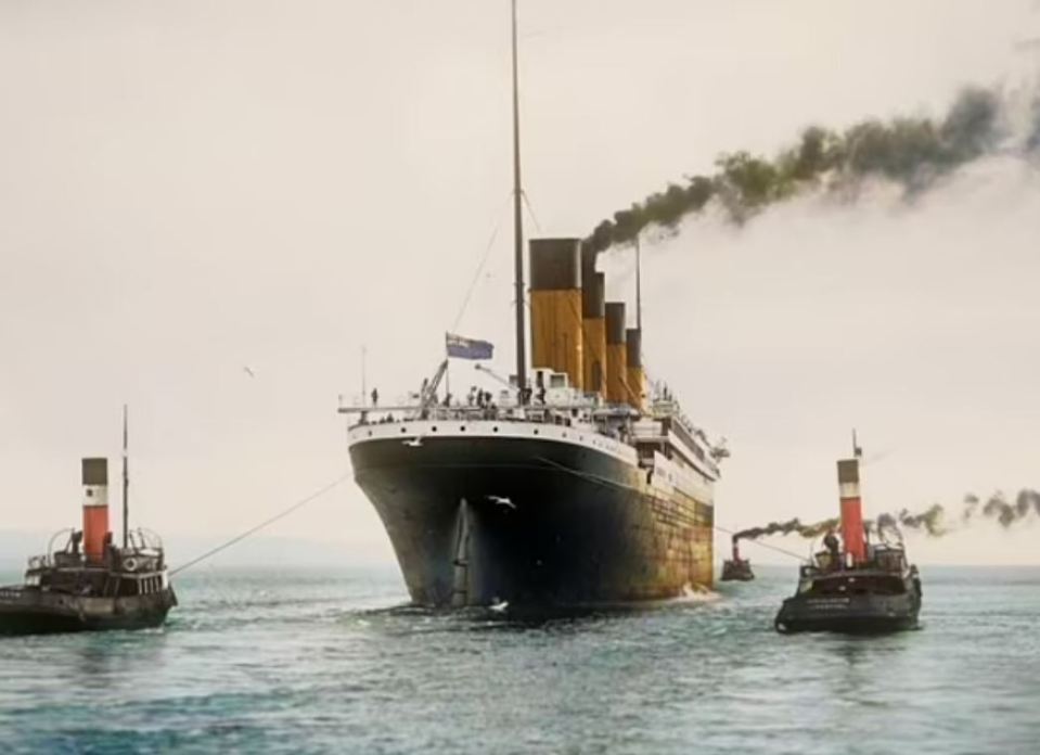 a large ship is being towed by two smaller boats