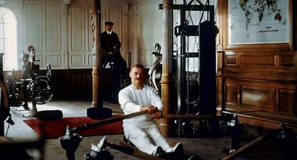 a man is using a rowing machine in a gym