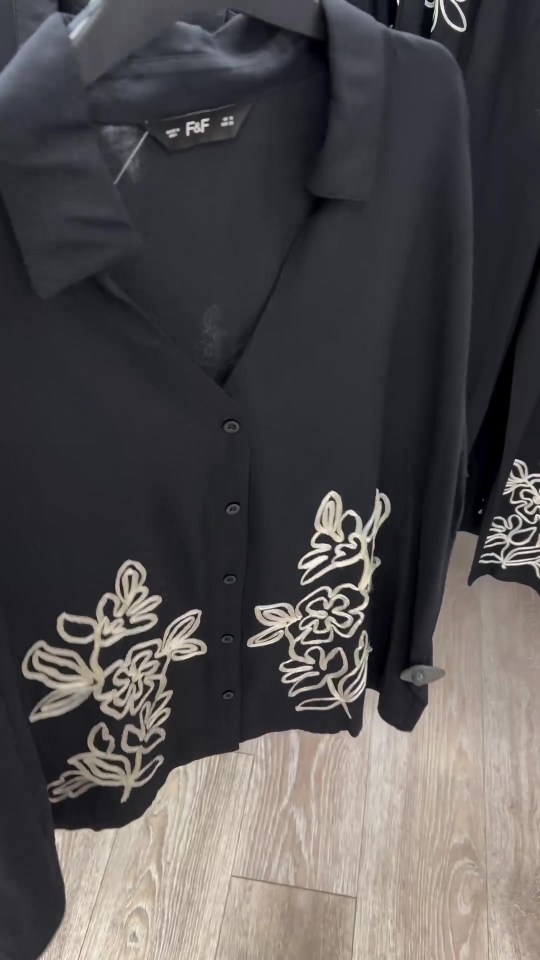 a black shirt with white embroidery and the word raf on it