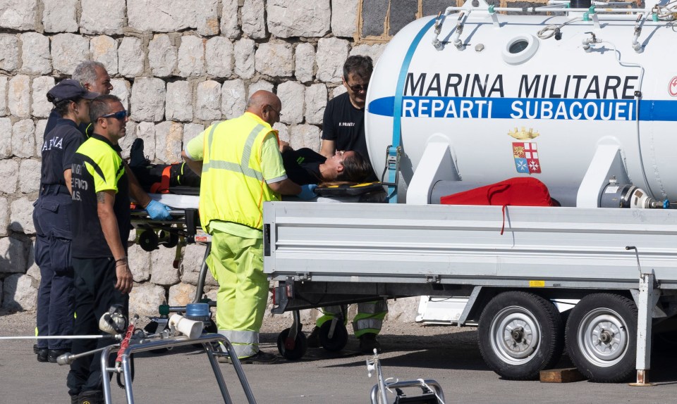 Dive rescue teams using a decompression chamber to recover after searching the wreck