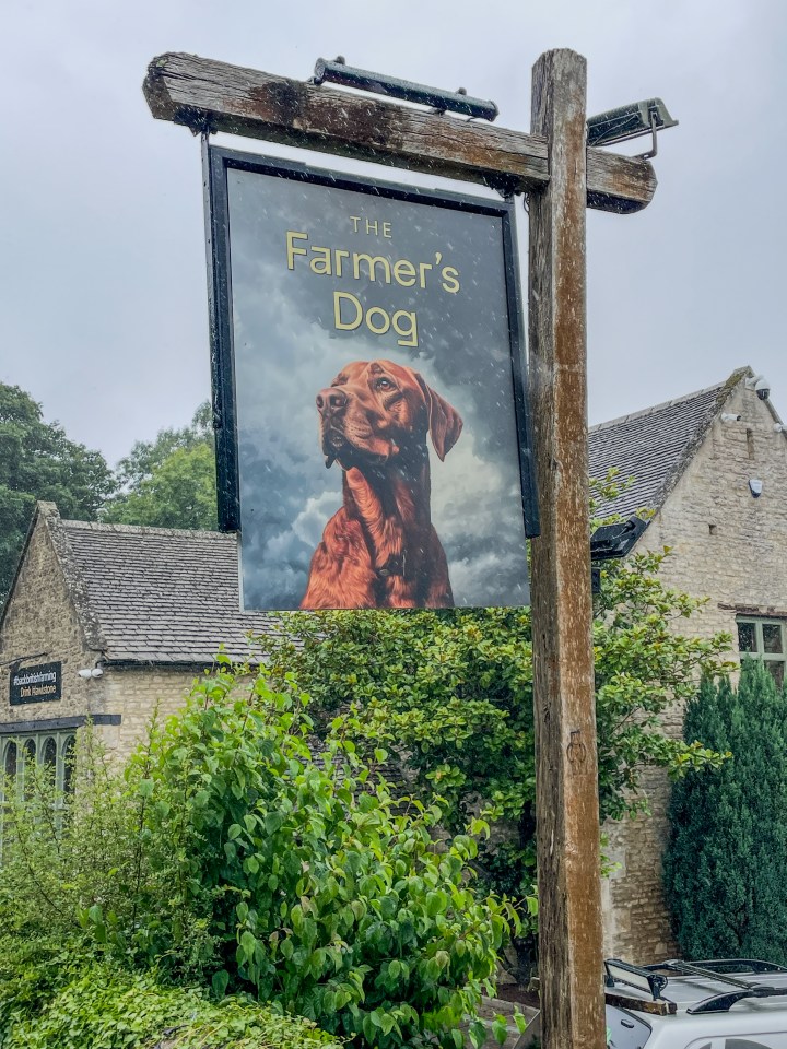 a sign for the farmer 's dog has a picture of a dog on it