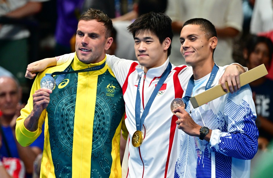 Pan poses with silver medallist Kyle Chalmers and bronze winner David Popovici