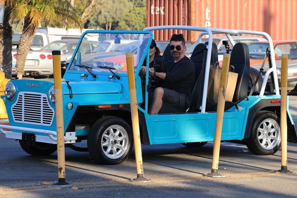 Simon and Lauren were hard to miss in their bright blue electric car