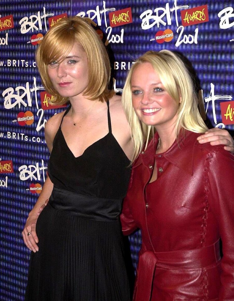 two women posing in front of a wall that says brit awards 2001