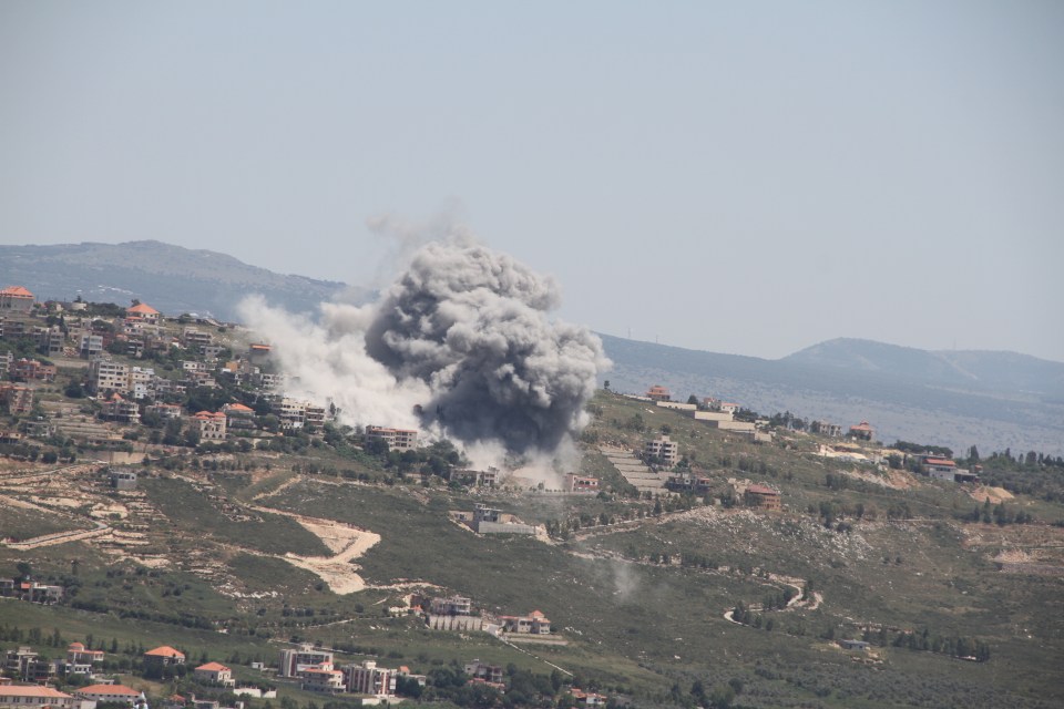 a large cloud of smoke is coming out of a mountain