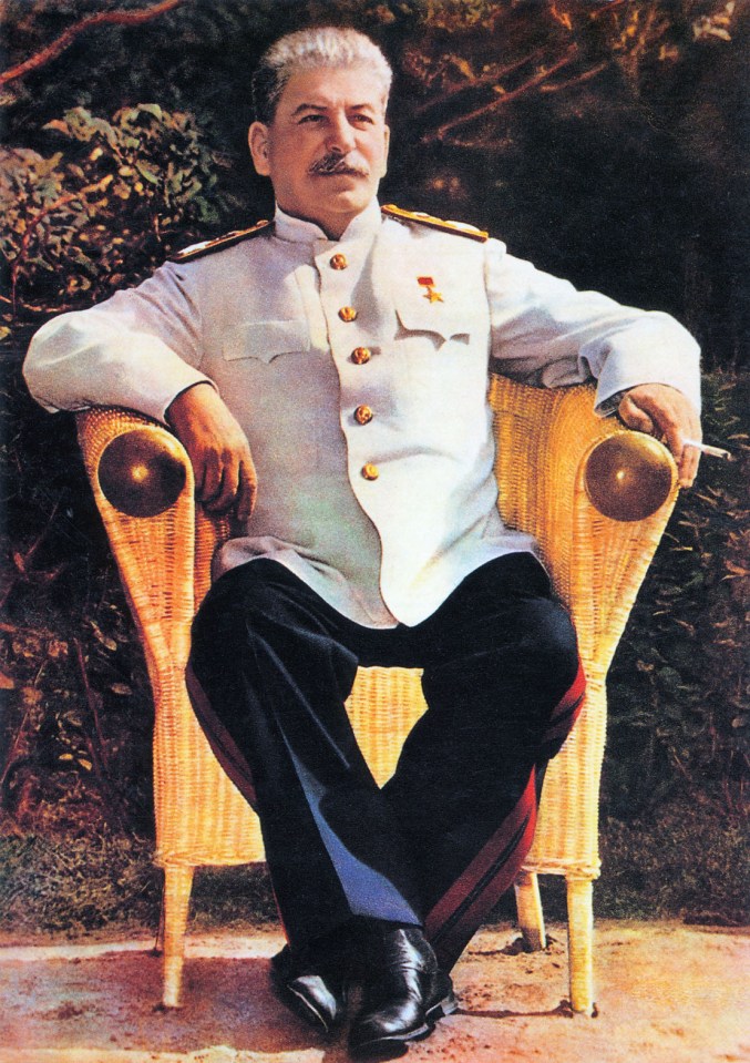 a man in a military uniform sits in a wicker chair