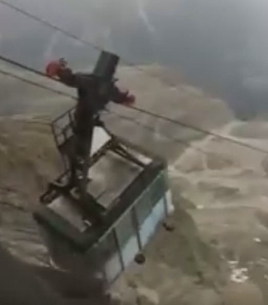 A group of tourists plunged into panic after a faulty cable car sways in the air for four hours