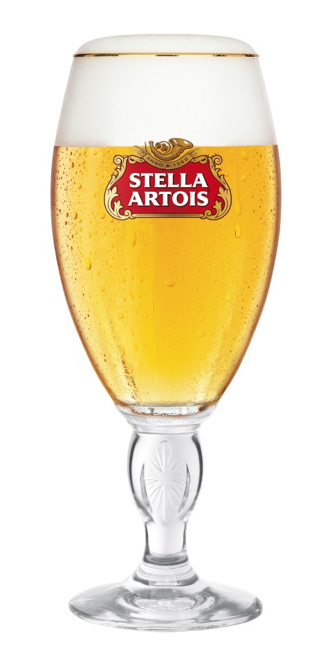 a full glass of stella artois beer on a white background