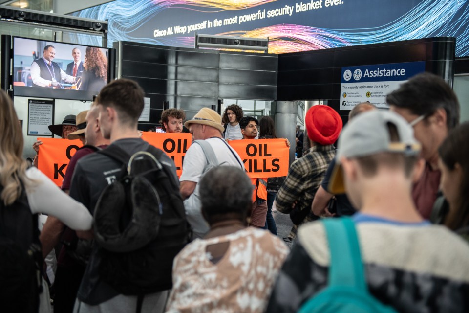 a group of people holding signs that say " oil kills "