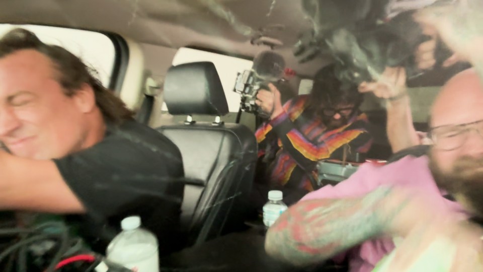 a group of people in a car with a bottle of water in the back seat