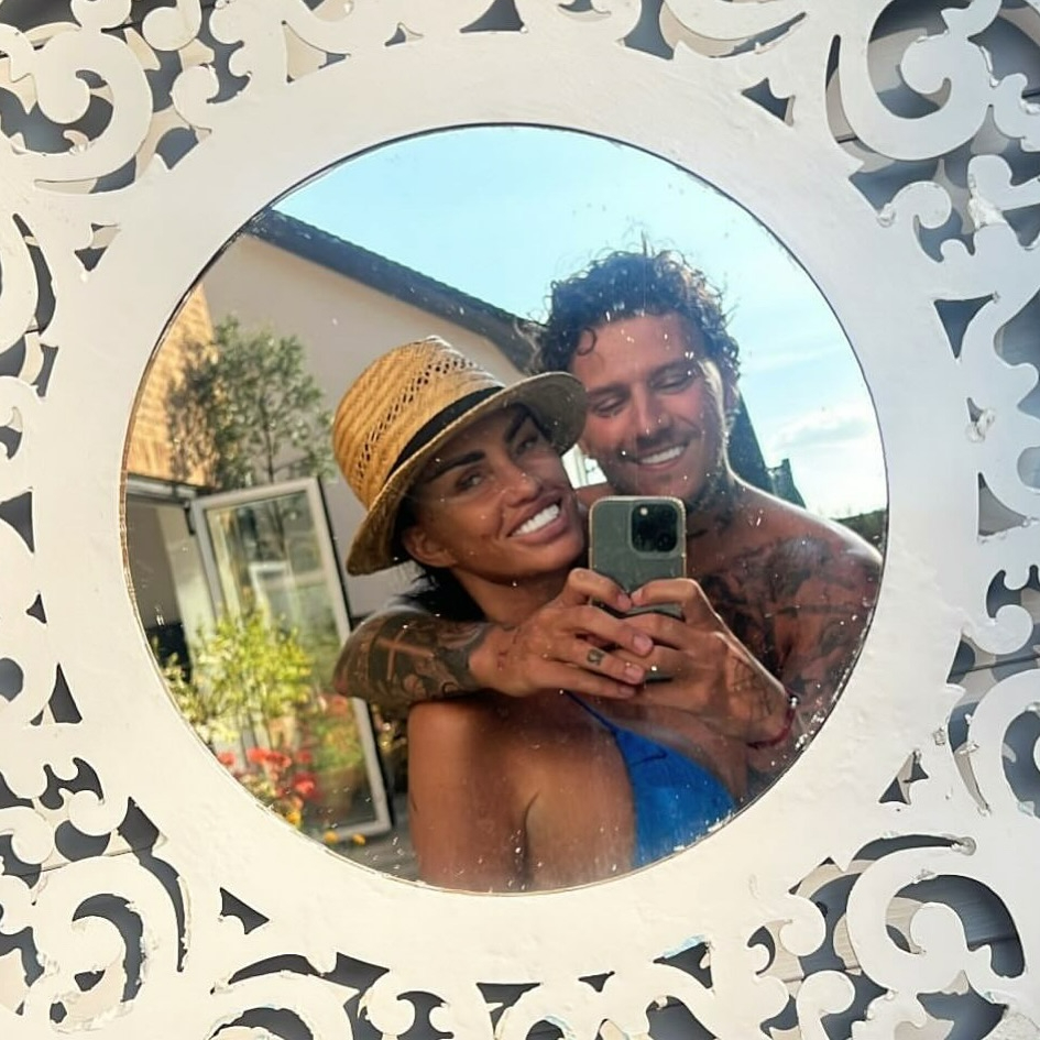 a man and woman are taking a selfie in a mirror