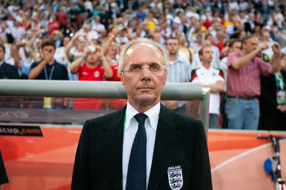 a man in a suit and tie with the word england on his shirt