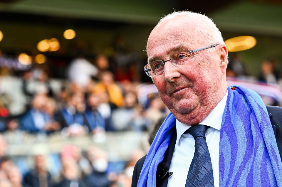 a man with glasses and a blue scarf around his neck