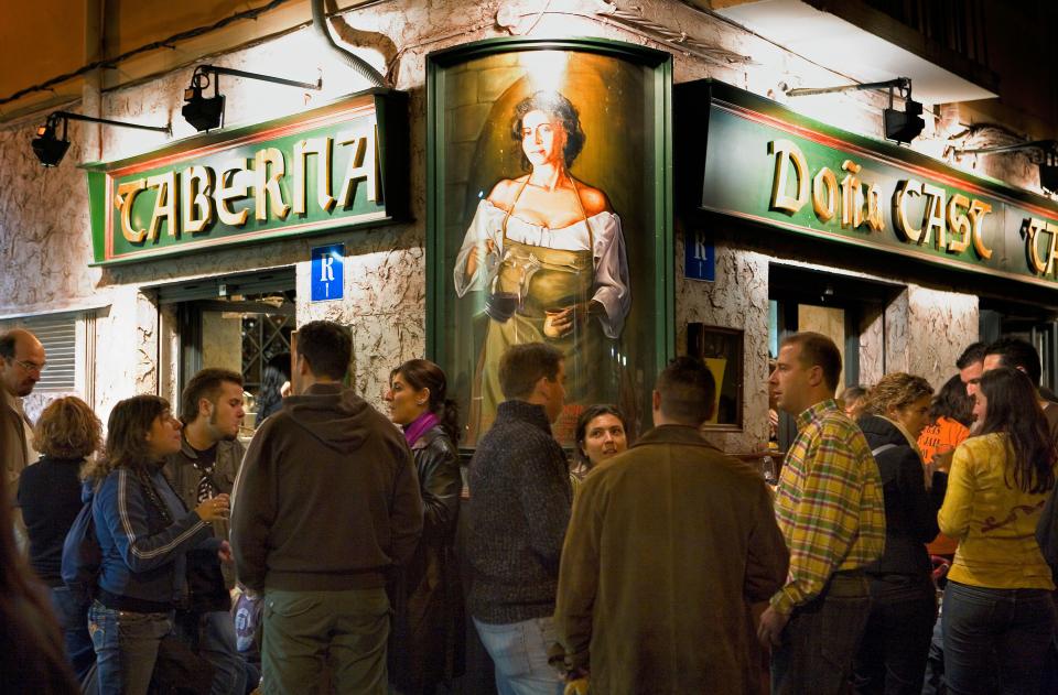 a group of people standing outside a restaurant called caberia