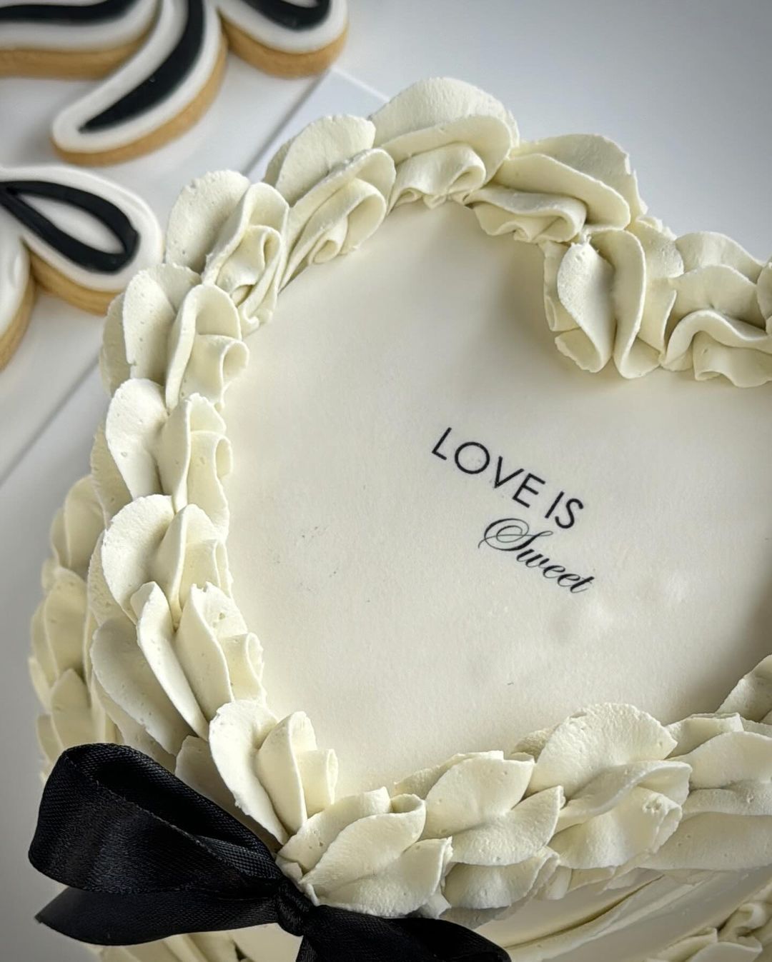 a heart shaped cake with the words love is sweet on it