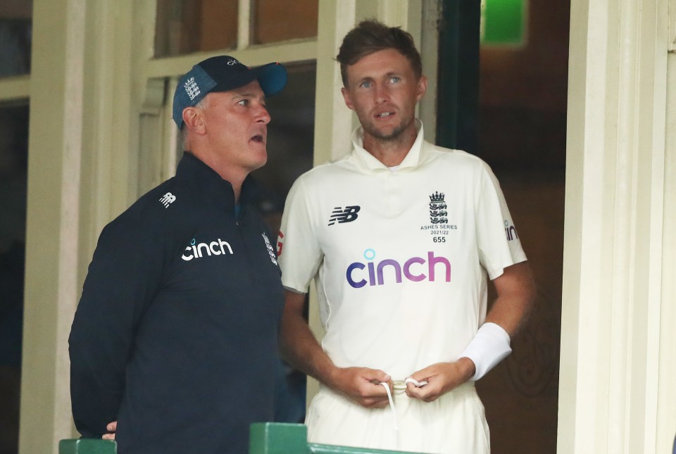 a man wearing a cinch shirt stands next to another man