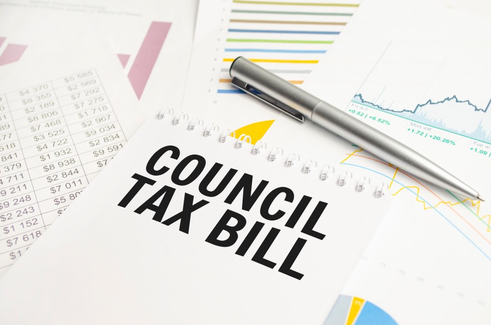 a pen sits on top of a notebook that says council tax bill