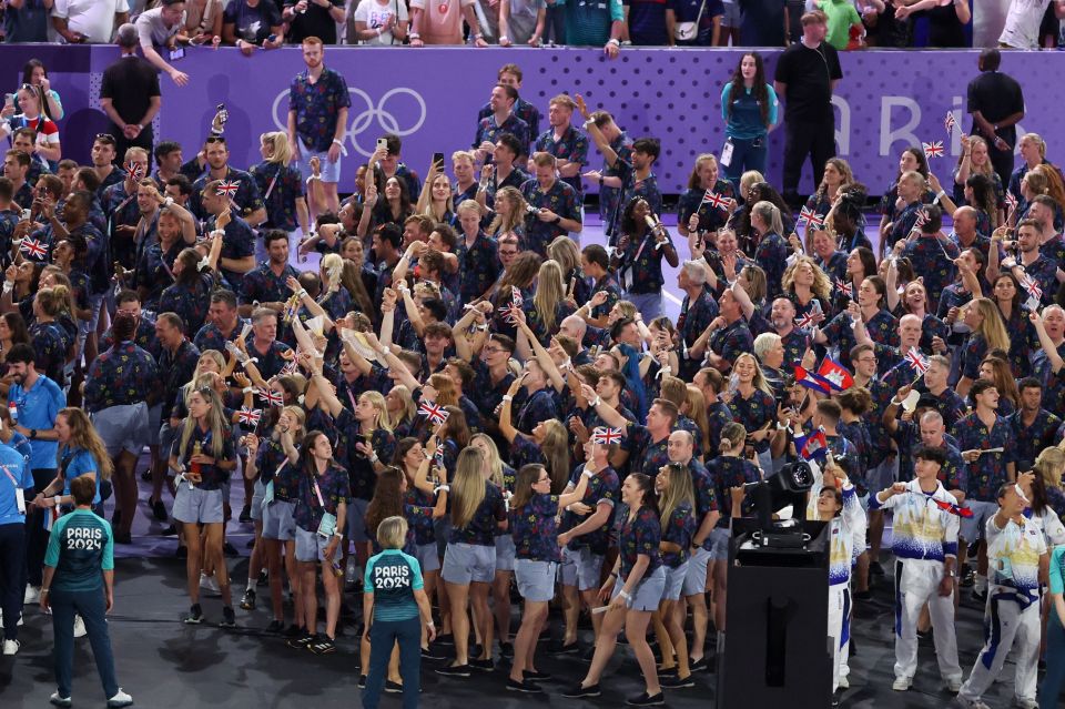 a group of people wearing shirts that say ' olympics 2012 ' on them