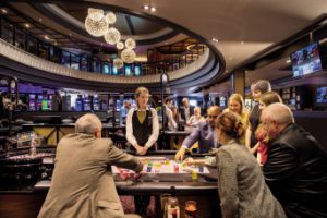 a group of people are playing roulette in a casino .