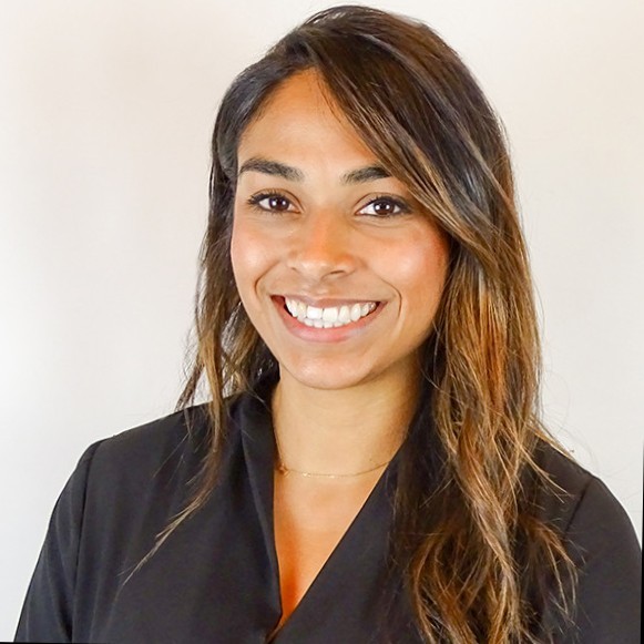 a woman in a black shirt smiles for the camera