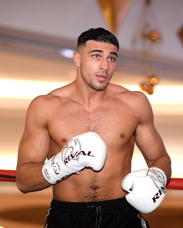 a shirtless boxer wearing rival boxing gloves