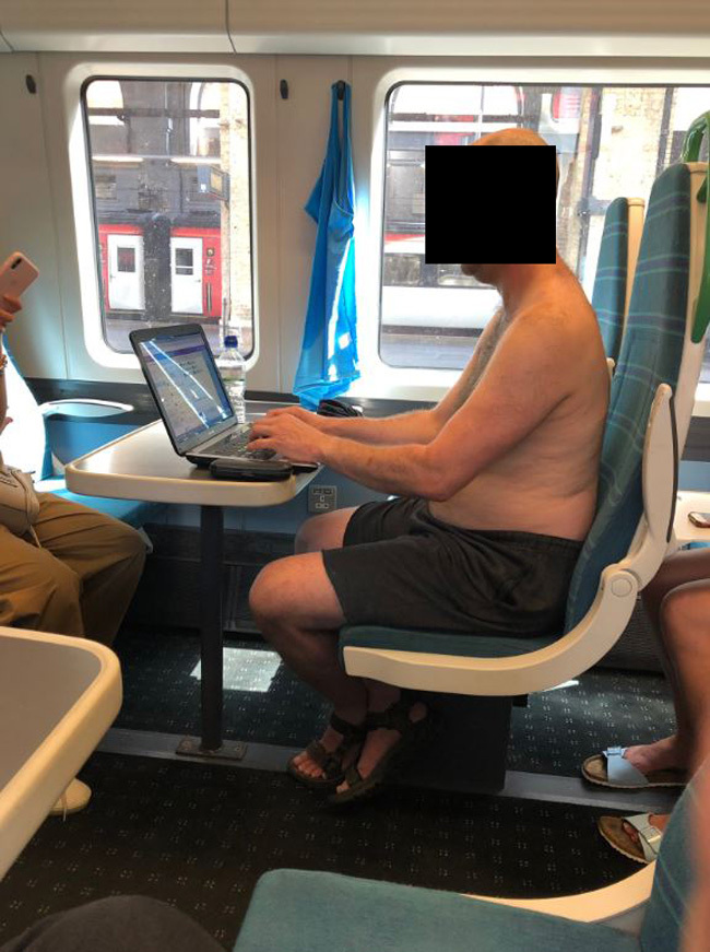 Topless man seen working on a train