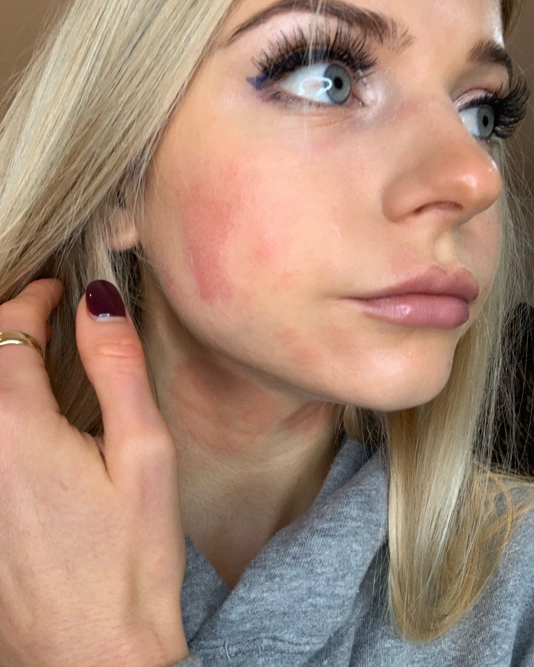 a close up of a woman 's face with a ring on her finger