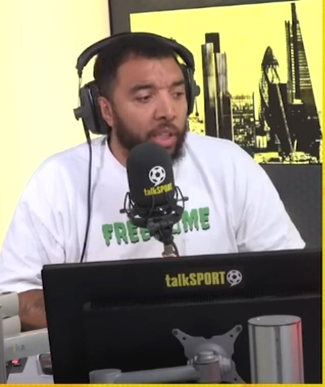 a man wearing headphones and a talksport shirt