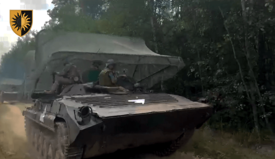 a military vehicle with a shield with a sun on it