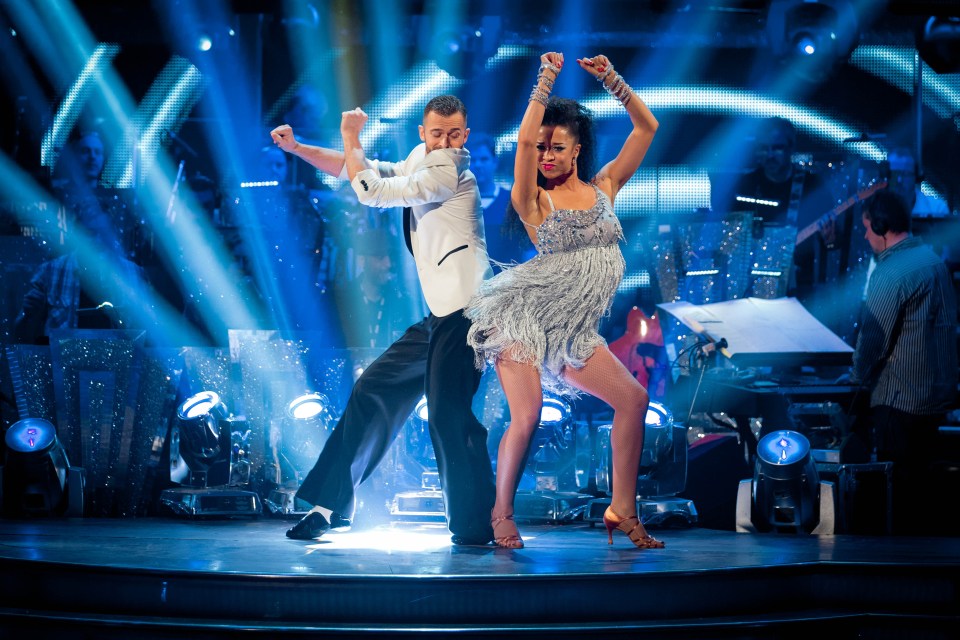 a man and a woman are dancing on a stage