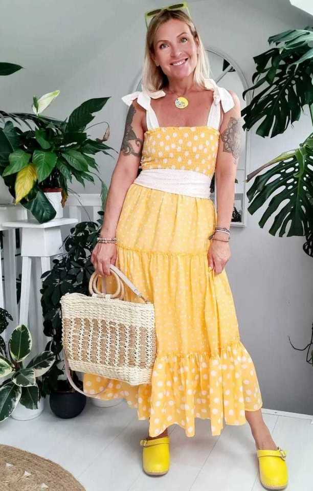 a woman in a yellow polka dot dress is holding a wicker bag