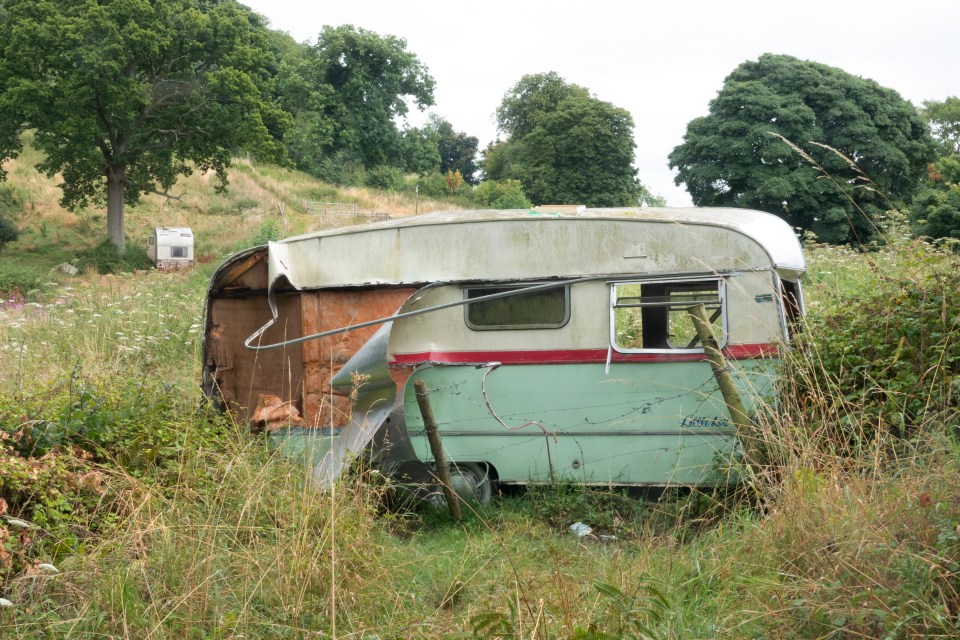 A landowner has blocked access to a beauty spot with a 'wall' of dilapidated caravans