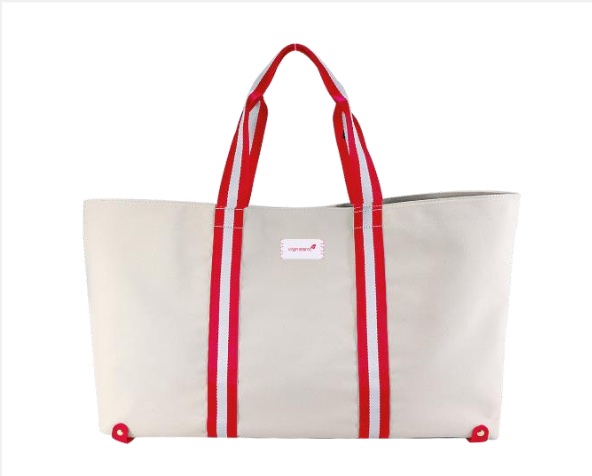 a white tote bag with red and white stripes on the handles