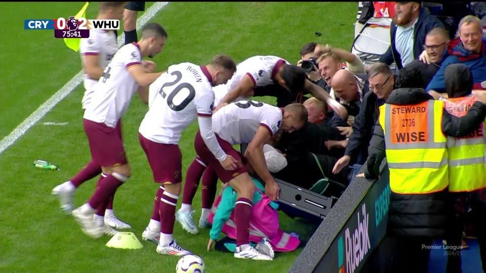 West Ham stars helped to lift the board up after it fell on him