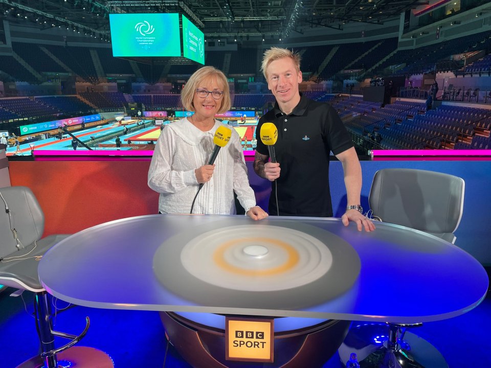 a man and a woman holding microphones in front of a table that says bbc sport