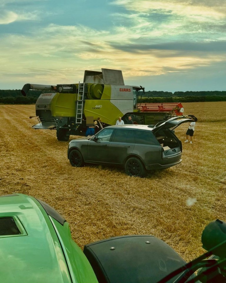 a claas combine harvester is in the middle of a field