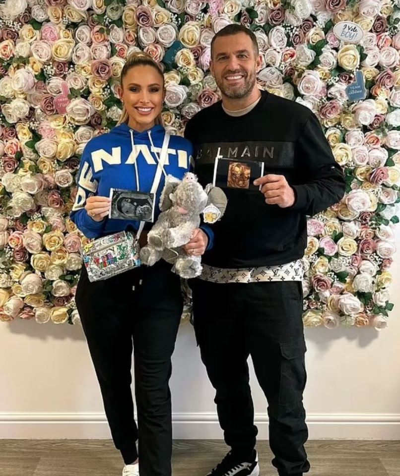 a man wearing a balmain sweatshirt stands next to a woman