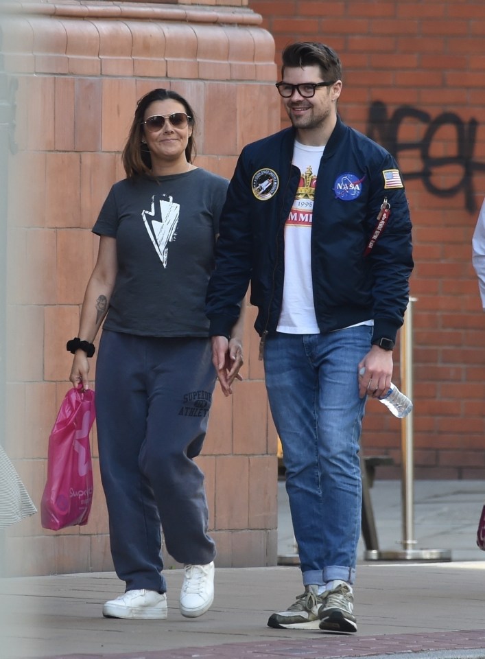 Kym Marsh looked loved up with her toyboy boyfriend Samuel Thomas as they took a stroll in Manchester