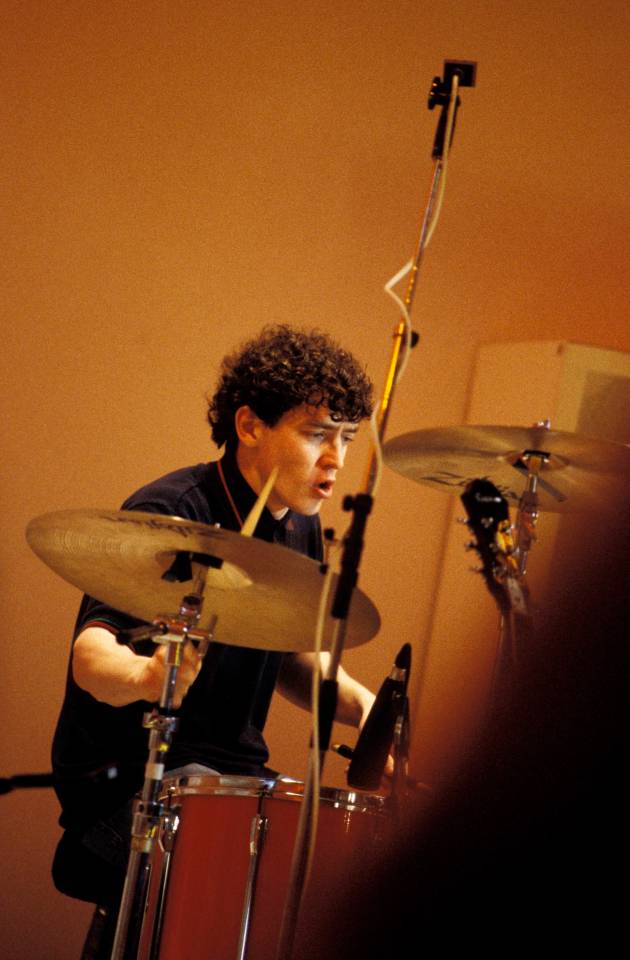 a man playing drums with a cymbal that says sabian on it