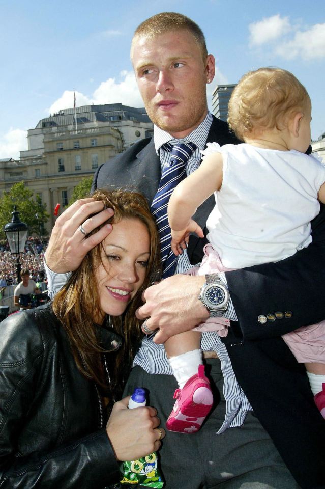 a man in a suit and tie is holding a baby