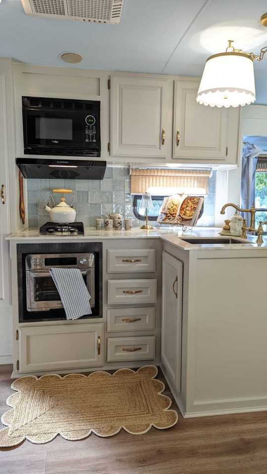 a kitchen in a camper with a microwave oven