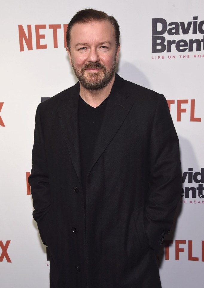 a man in a black suit stands in front of a netflix sign