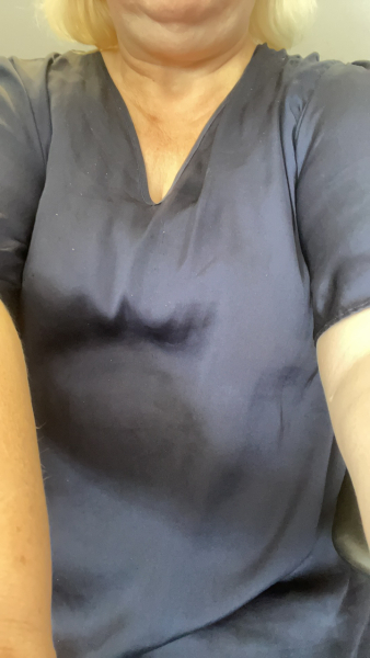 a woman is wearing a blue shirt with a v-neck