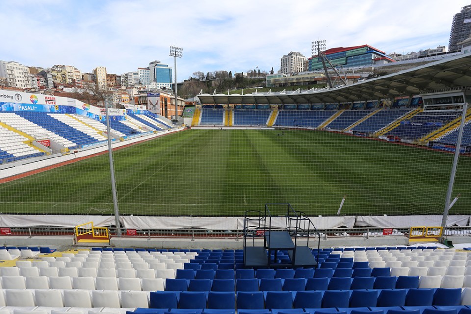 a soccer stadium with blue and white seats and a sign that says ' turkcell ' on it