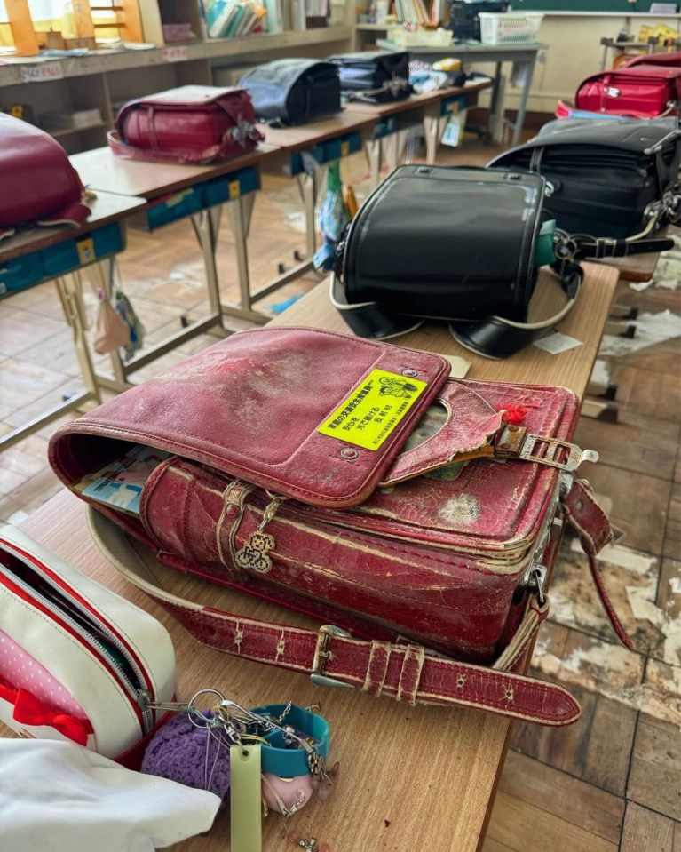 A worn out satchel lies on a desk as if it was used recently