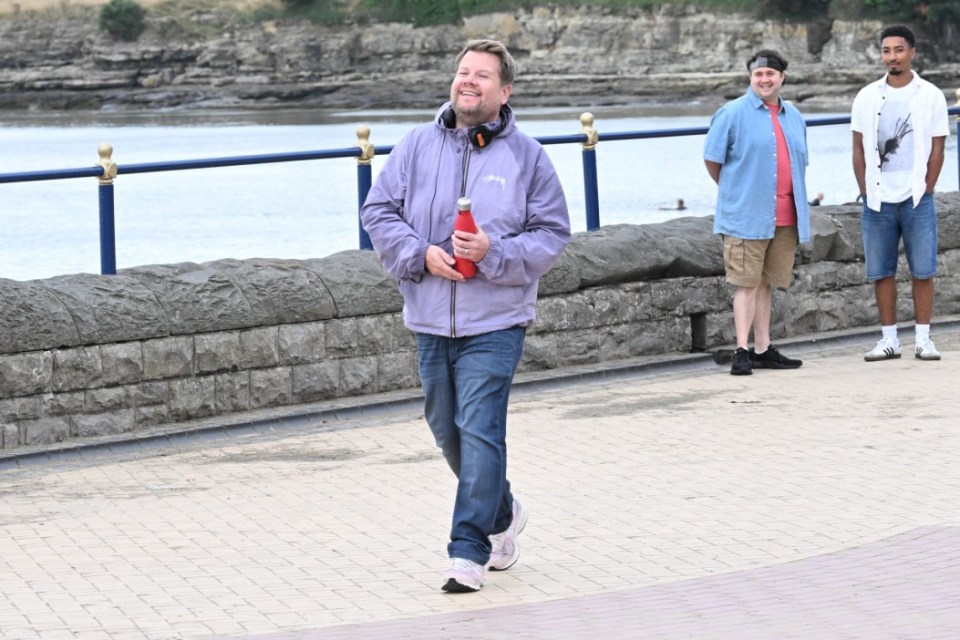 a man in a purple jacket with the word sydney on it