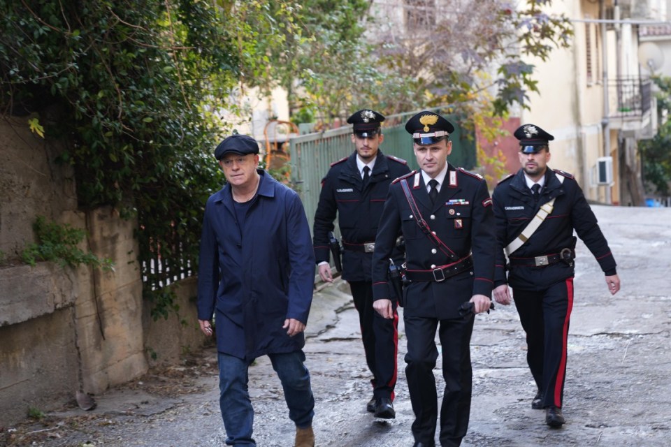 a group of police officers are walking down a street