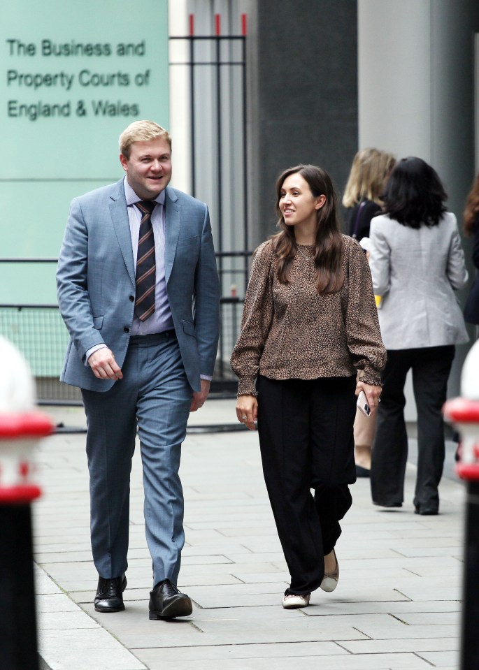 a man and woman are walking in front of a building that says the business and property courts of england and wales