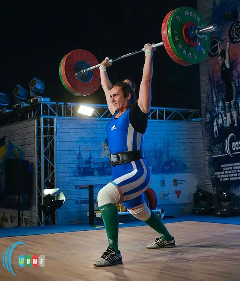 a man lifts a barbell with the word werk on it