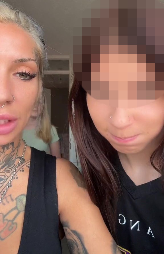 a woman with a tattoo on her arm is standing next to another woman